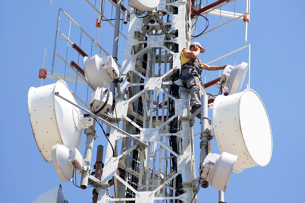 Technician doing maintenance on microwave radio